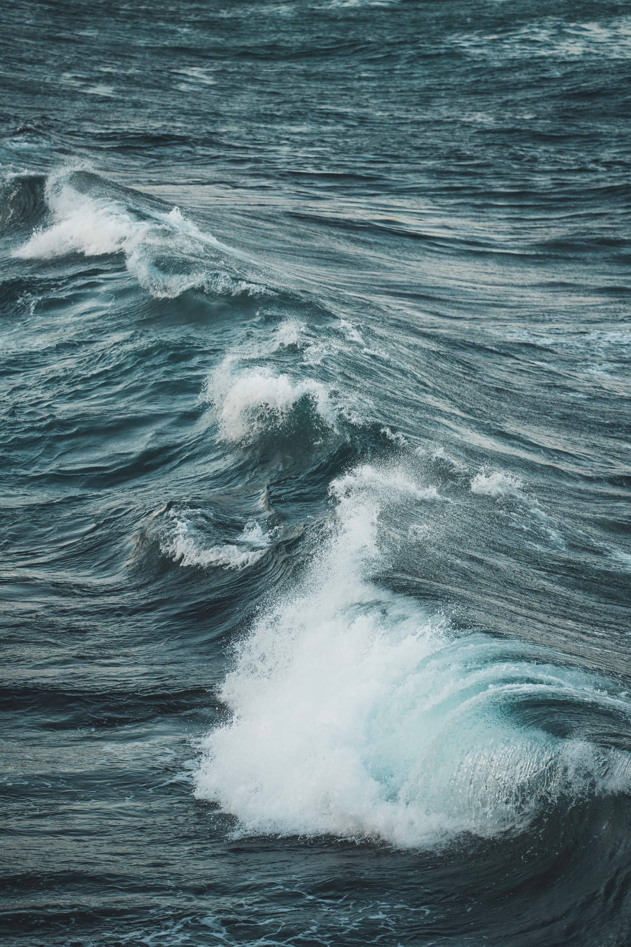 Rough ocean waves with white foam and deep blue water