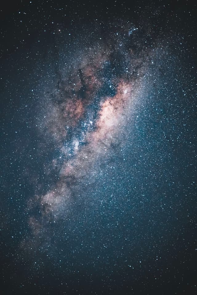 A vibrant view of the Milky Way galaxy with dense clusters of stars and cosmic dust set against a dark night sky